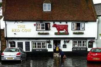 Pub bosses put out sandbags as the water rises around the Red Cow