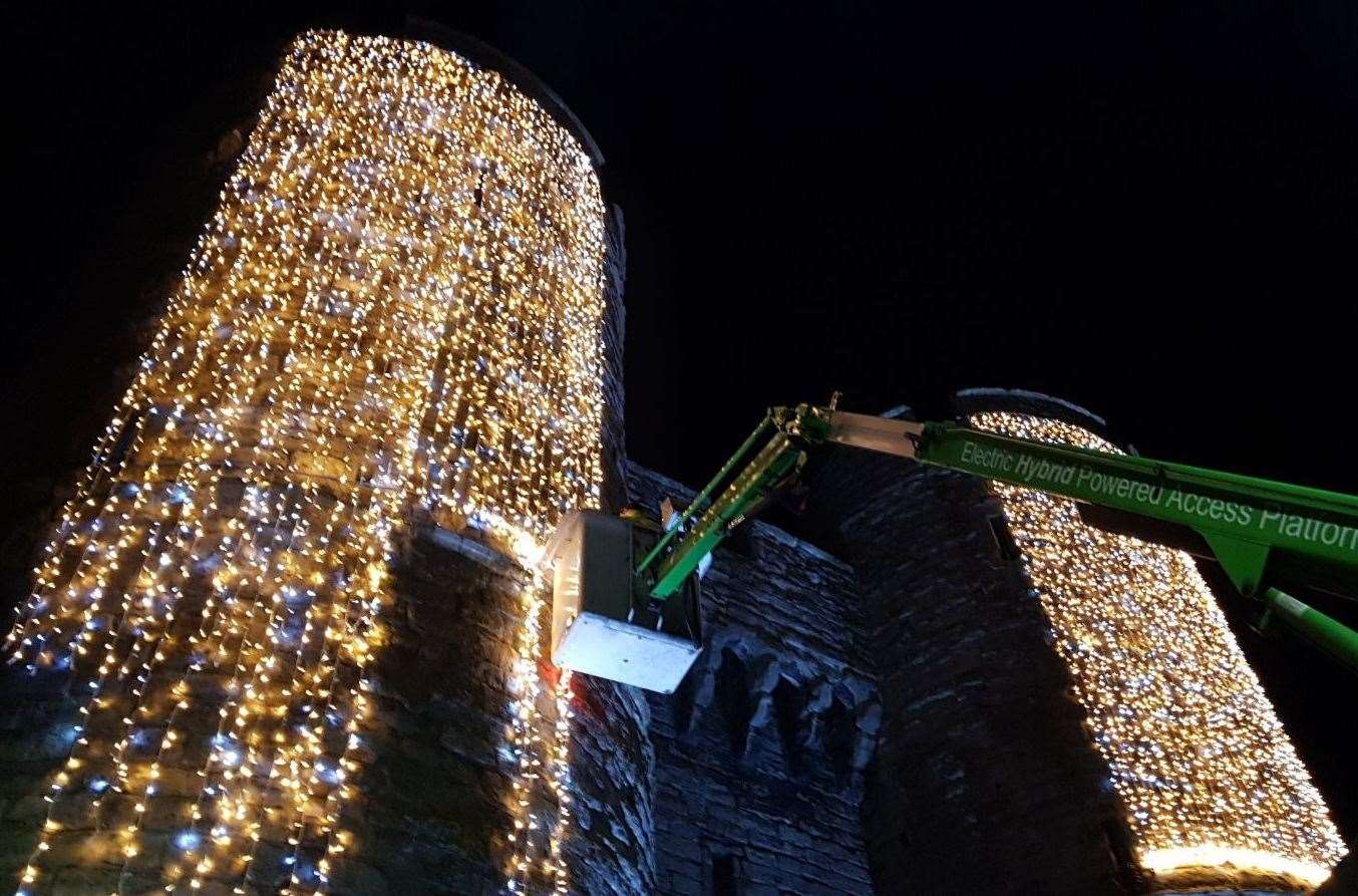 Workers installing lights on Canterbury's Westgate Towers