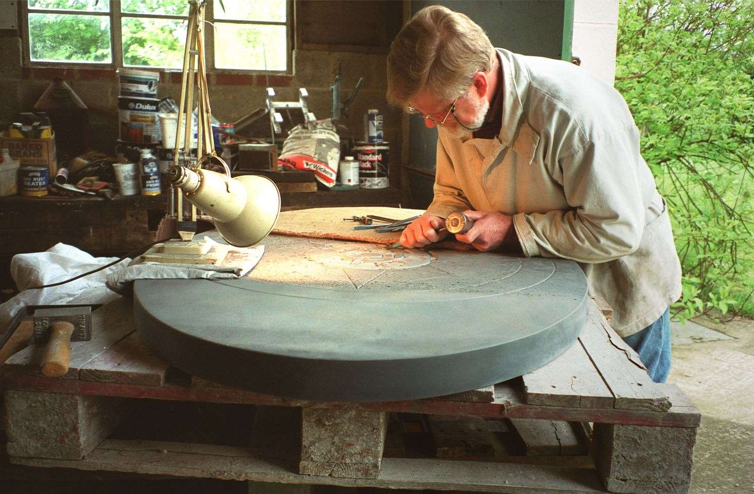 Michael Rust of Hastingleigh finishing carving the Cumberland slate Compass Rose which was put at the top of Wye Crown in 2003