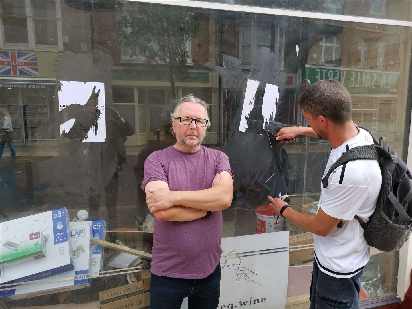 Dave Robinson outside his defaced shop window