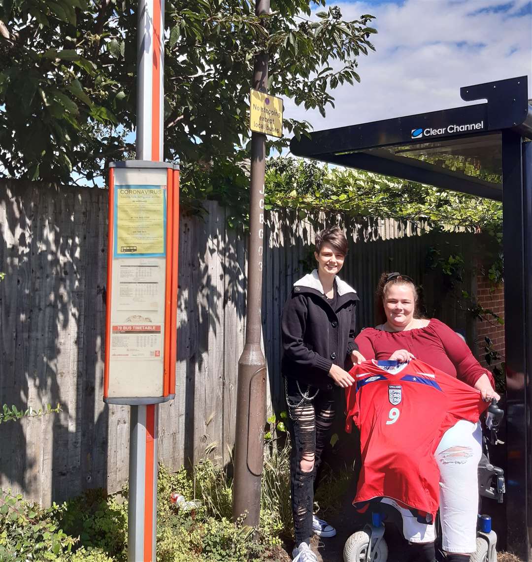 Larkfield resident Emma Wild and her daughter at the Southey Way bus stop in Chaucer Way. Ms Wild is pictured with her England shirt she wore last week when trying to get to the Euros game