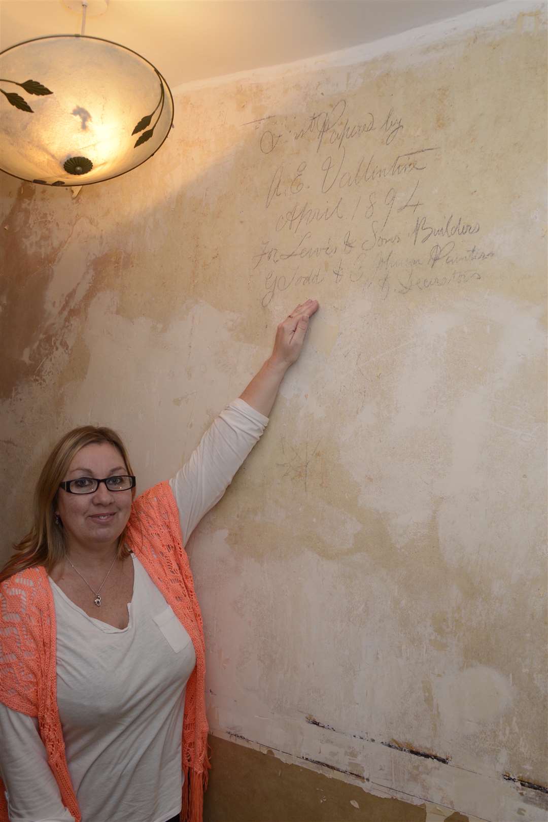 Catherine Carter with the message left on her wall that she found while decorating her Buckland Avenue home