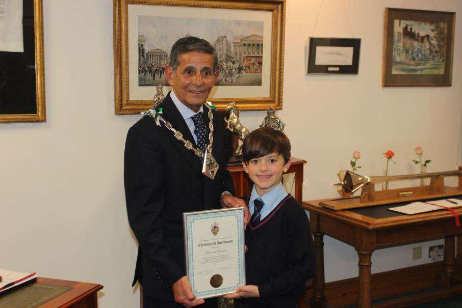 Mayor of Ashford Cllr Winston Michael presents the award to nine-year-old Harrison Cummins