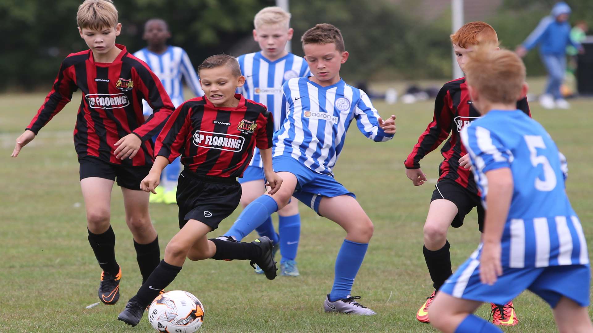 Woodcoombe FC's under-12s (red and black) in possession against Chatham Riverside Rangers in the League Cup Picture: Grant Melton