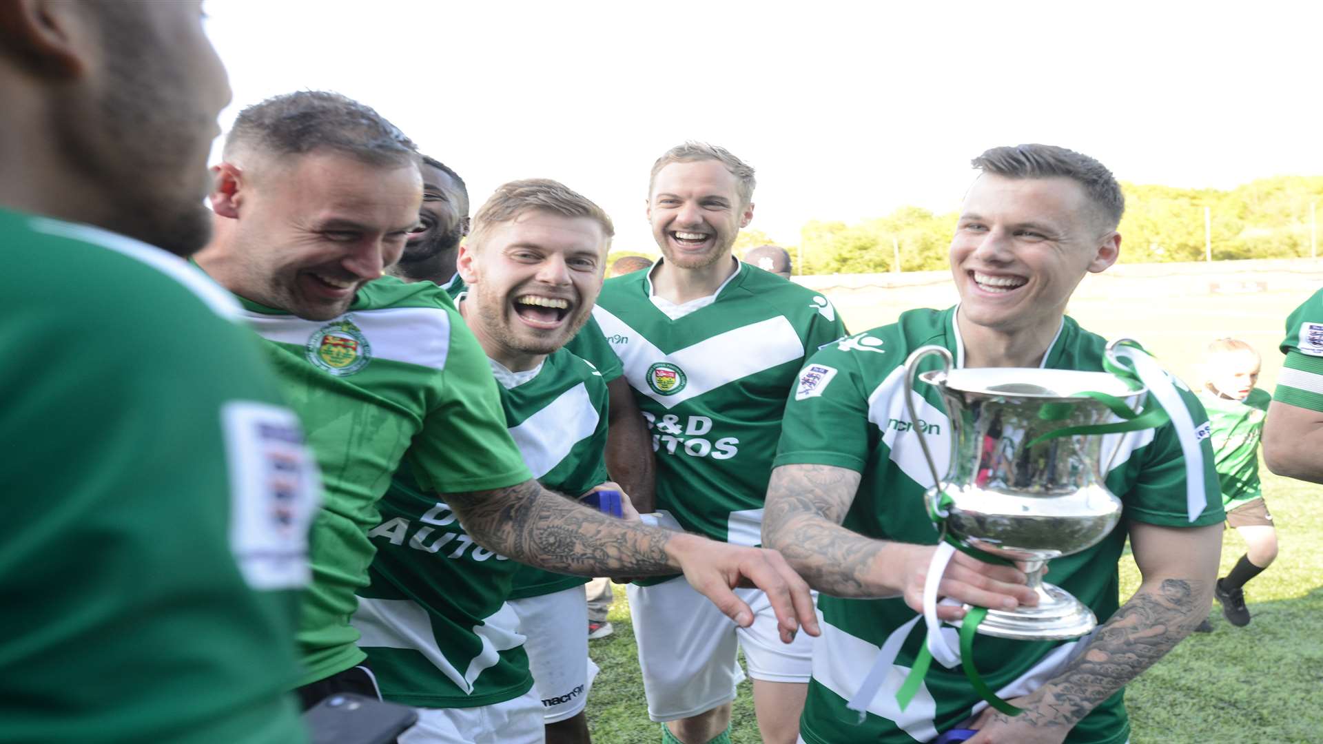 Manager Danny Lye (second left) celebrates with his players after winning promotion in April