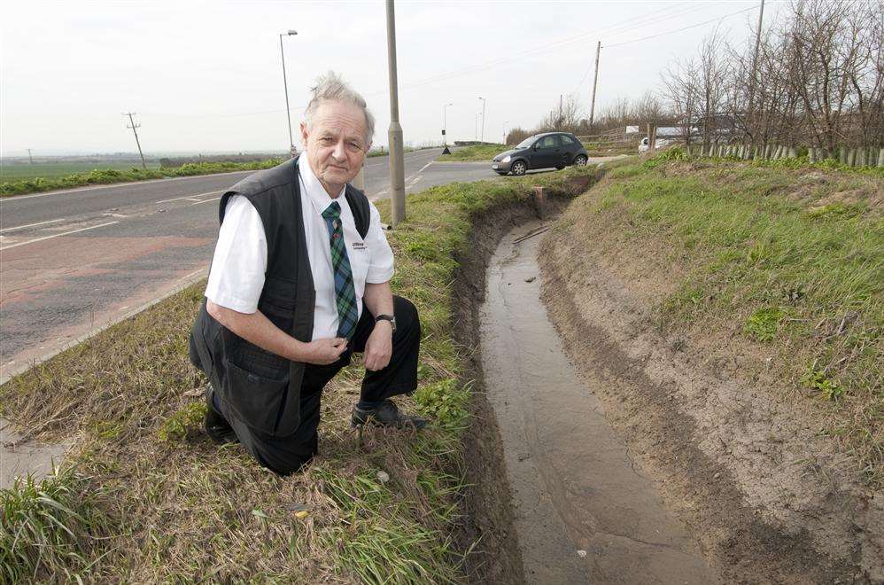James Morrison beside a drainage area he believes was partly responsible for the flooding