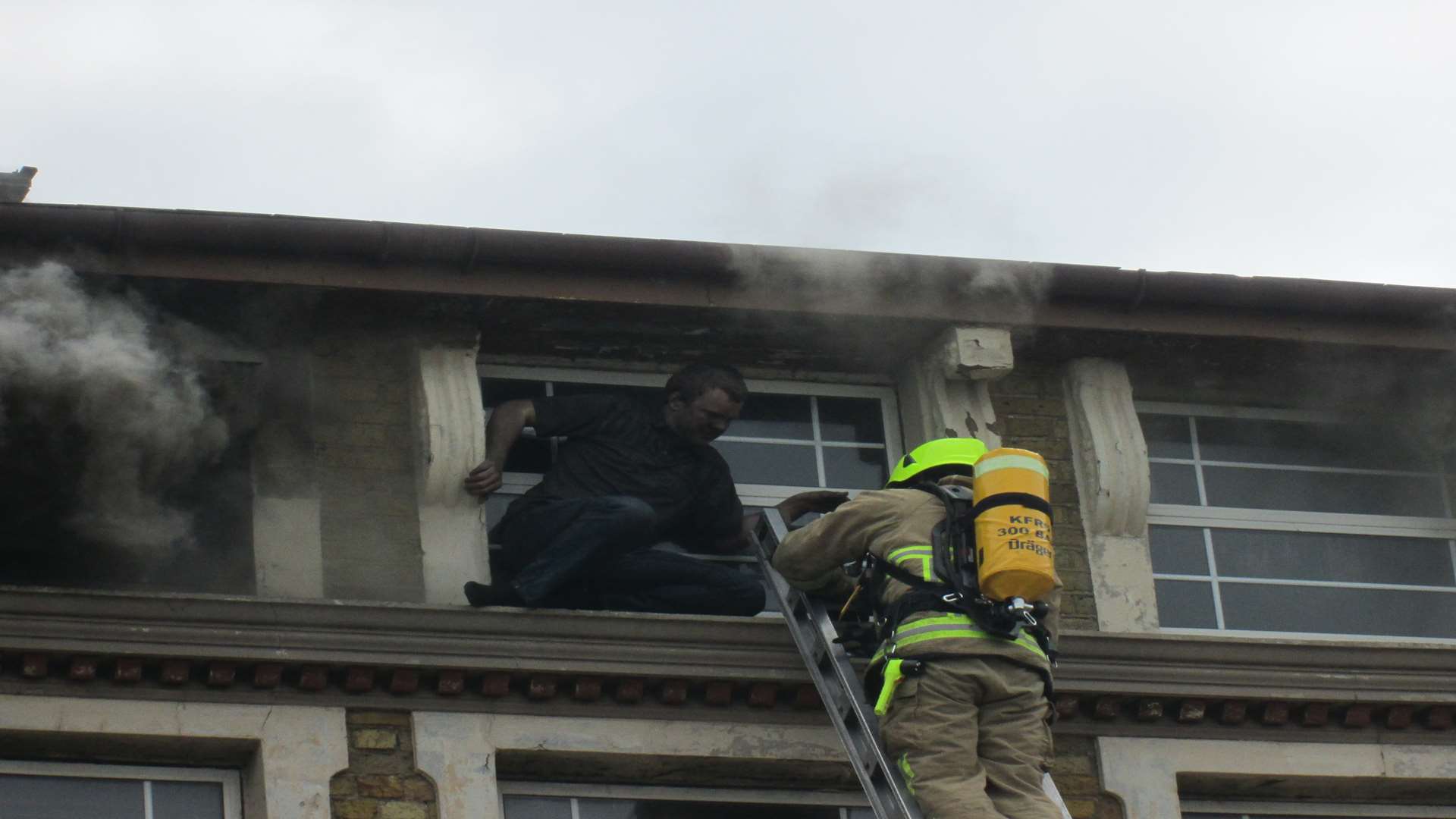 Craig climbs from the top floor window