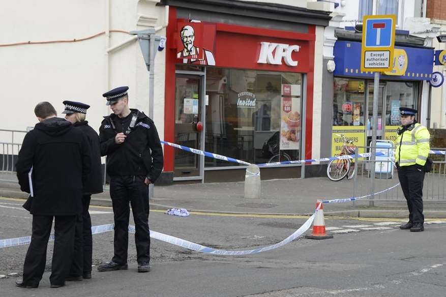 Officers at the scene of the attack outside KFC