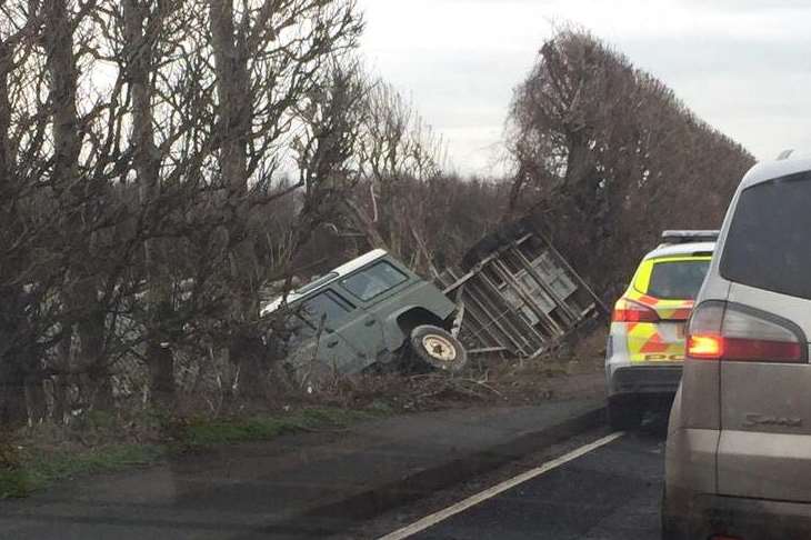 Land Rover has come off the road and landed in a ditch.