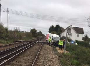 The van with its bonnet smashed is knocked to the side of the tracks at Teynham. Picture: British Transport Police