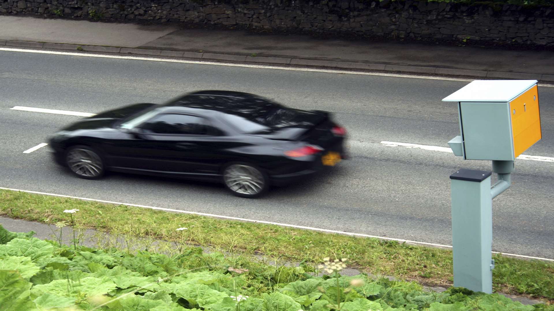 Stock picture of a sportscar going past a speed camera. Credit: iStock