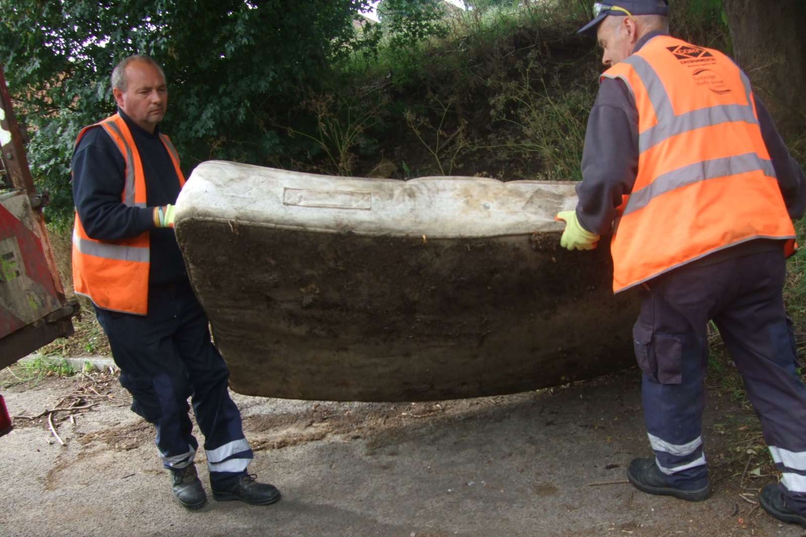 Member of the Tunbridge Wells Council street cleaning team remove a dumped mattress