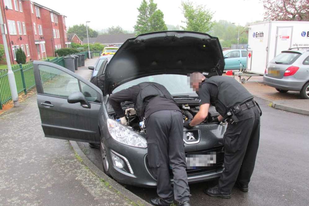 Police searching a car during the operation in Snodland