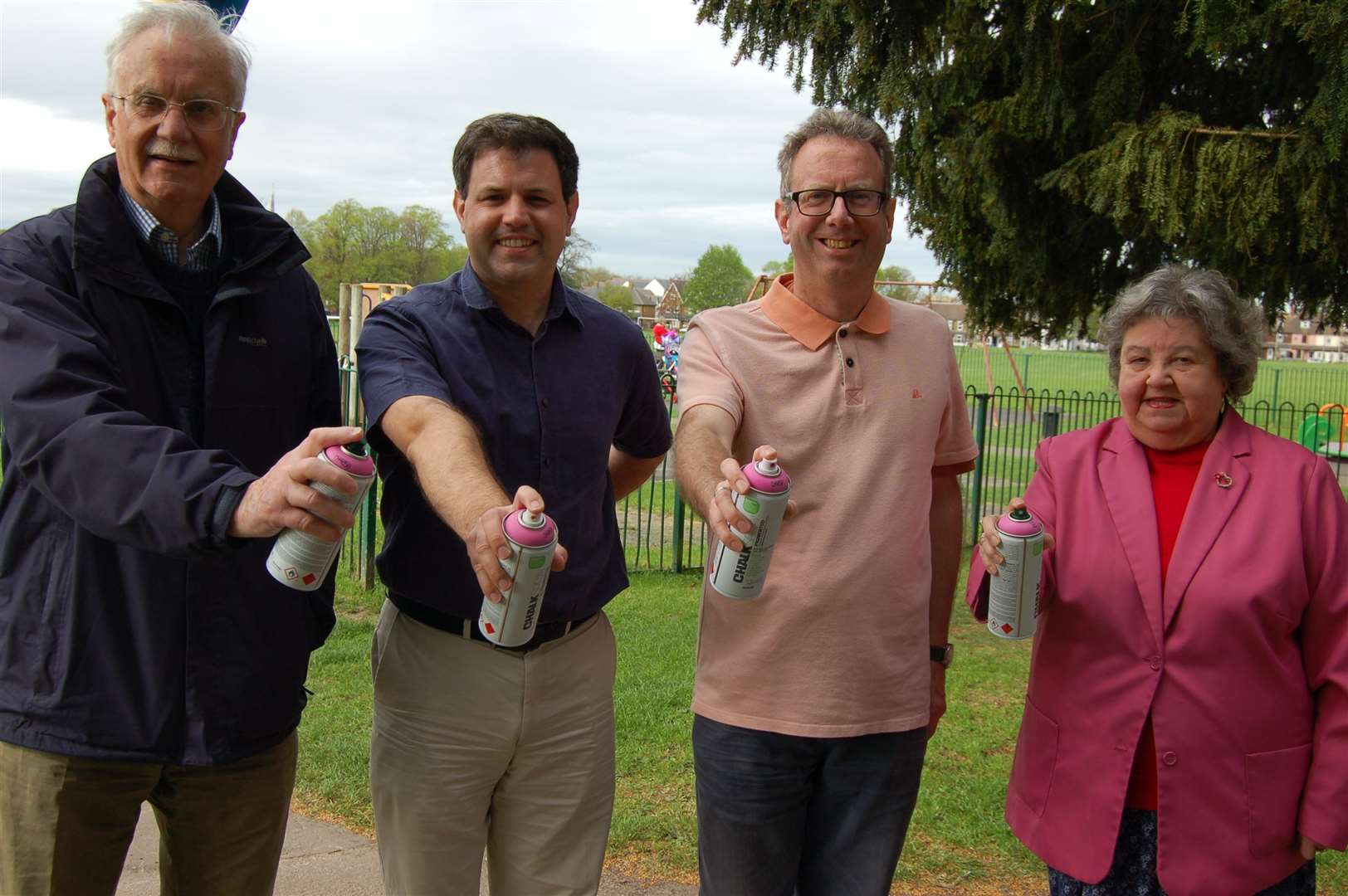 Anita Walker, pictured right, alongside fellow town councillors at Faversham Rec with the tins of florescent pink paint used to highlight the town's dog fouling problems