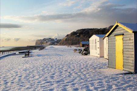 Colourful beach huts contrast the snow at Kingsdown, near Deal. Picture: Gemma Green