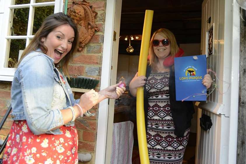 kmfm's Emma Saint presents listener Michelle Smith with her prize in Marden