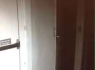 A door can be seen opening in the video