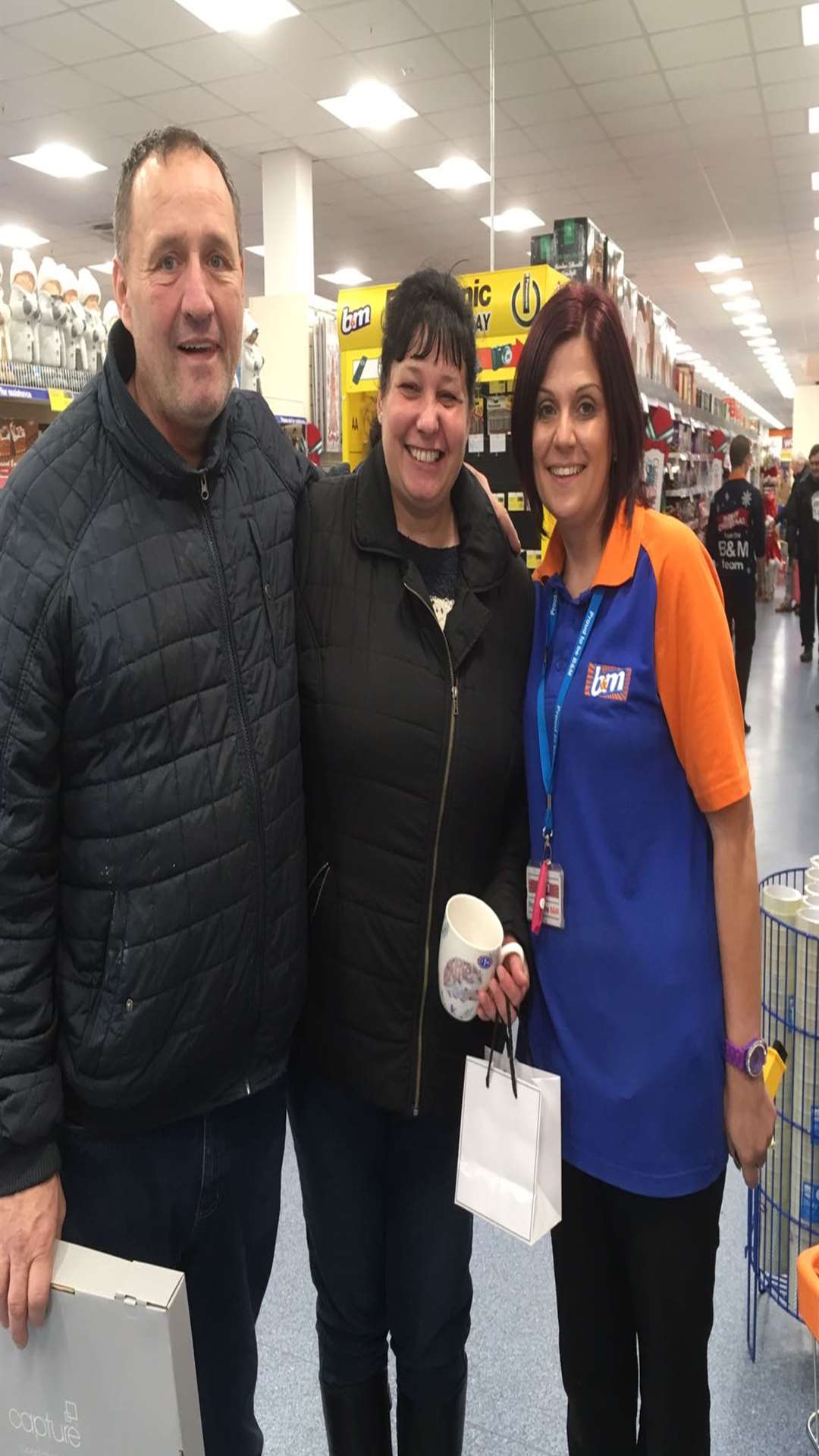 Ann Russell (centre) with fiance Robin at the B&M store in Gravesend