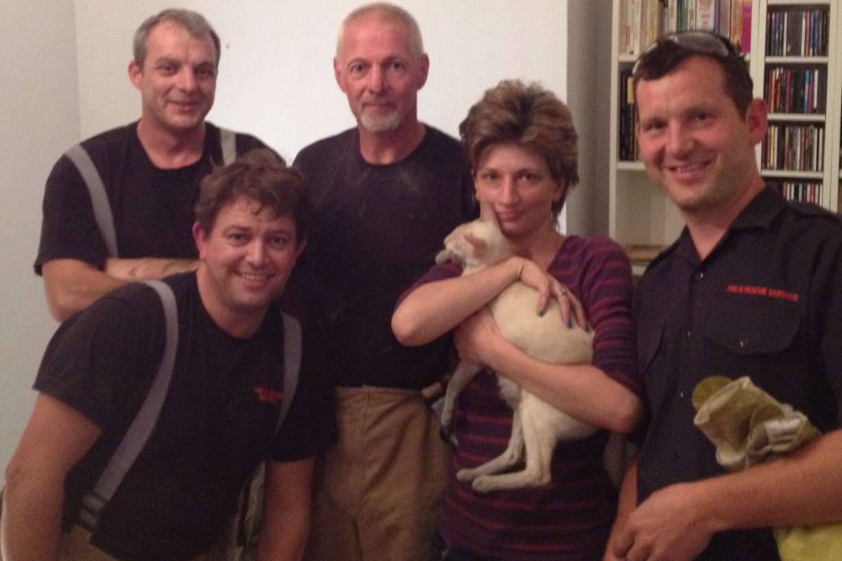 Theresa Buckland with her cat Frank after he was rescued from a chimney by firefighters