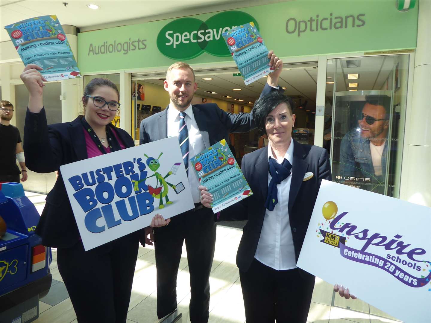 Buster's Book Club Ambassador Benita Lowe, right, joins Molly Salter and Robert Marsden of Specsavers Ashford branch to promote the reading reward scheme. (16017803)