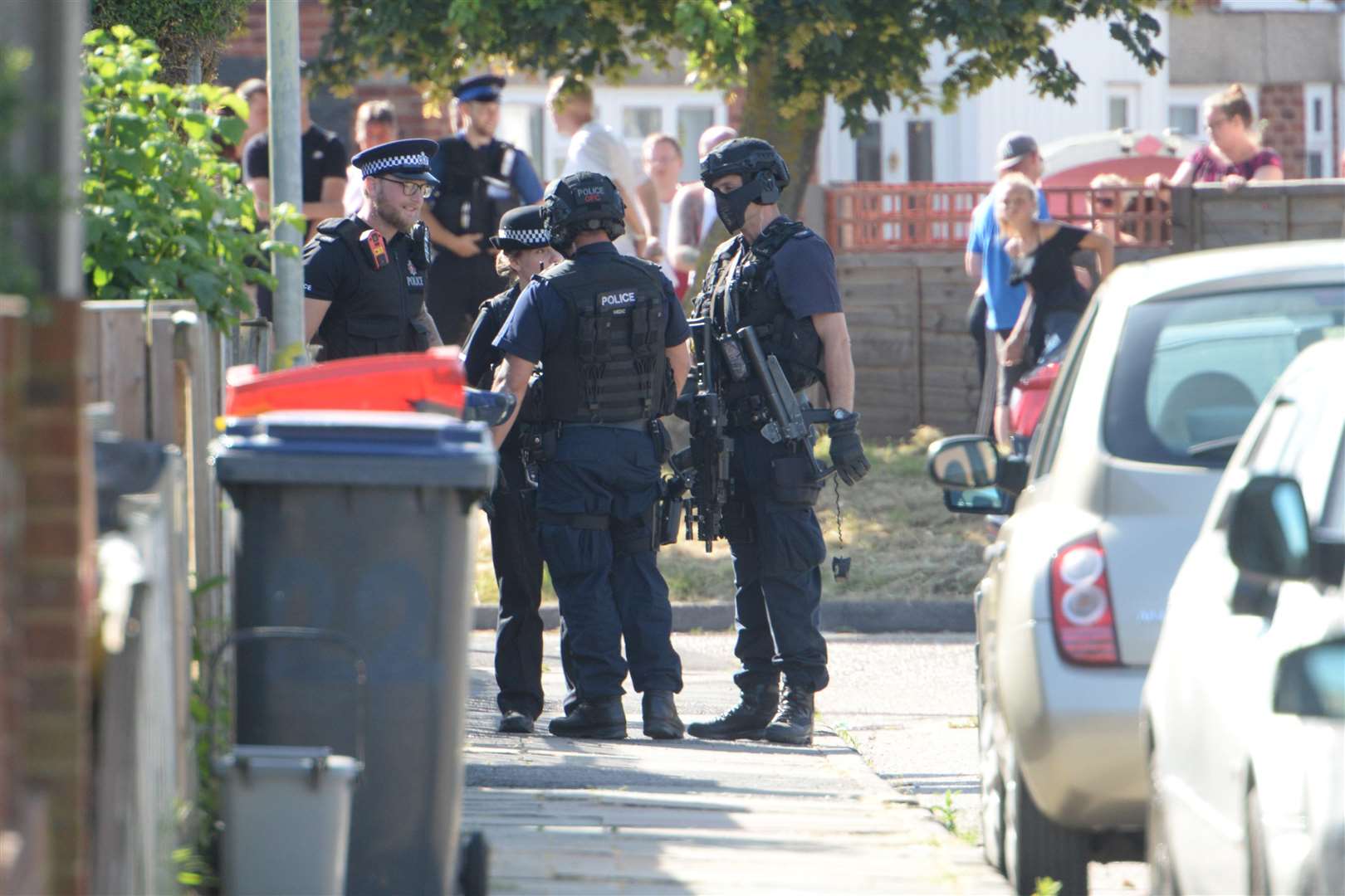 Residents look on during the heavy police presence Picture: Chris Davey