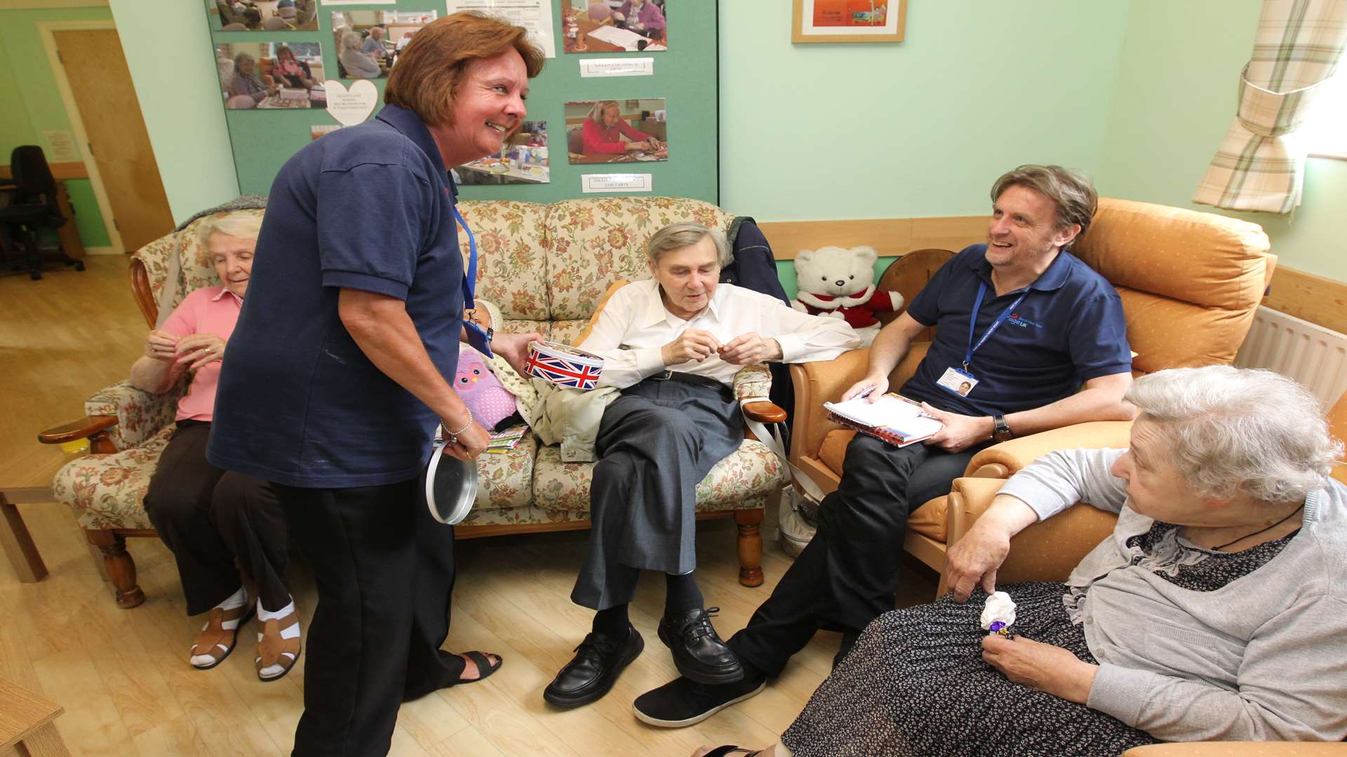 Support worker Elaine Harris passes around sweets