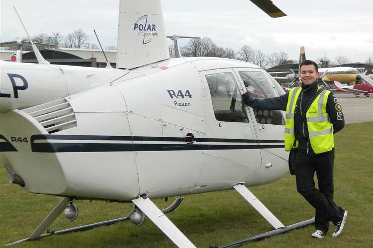 Sheppey teenager Paul Smith next to a helicopter