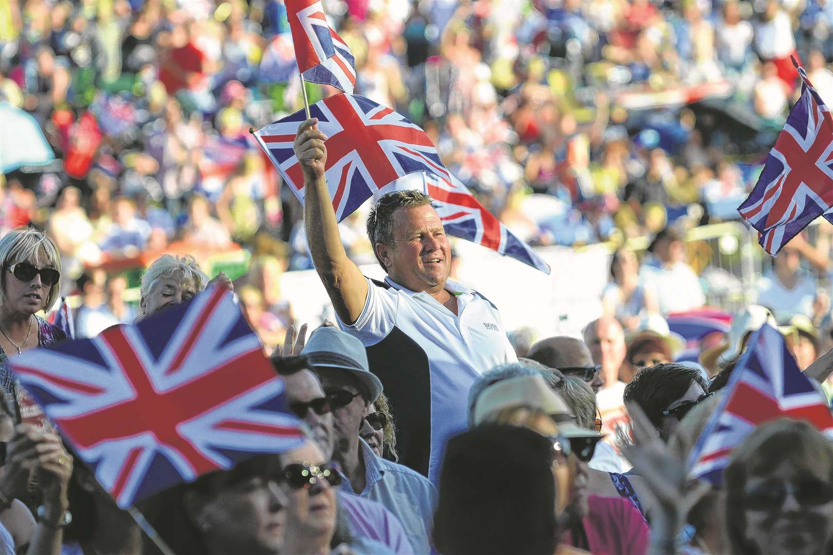 Spectators wave their Union flags at the Leeds Castle Classical Concert