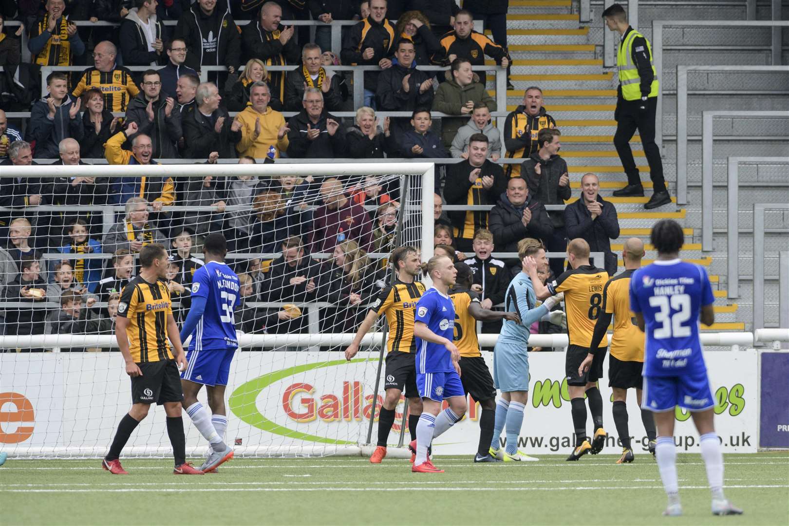 Lee Worgan is mobbed by his team-mates after saving a Halifax penalty Picture: Andy Payton