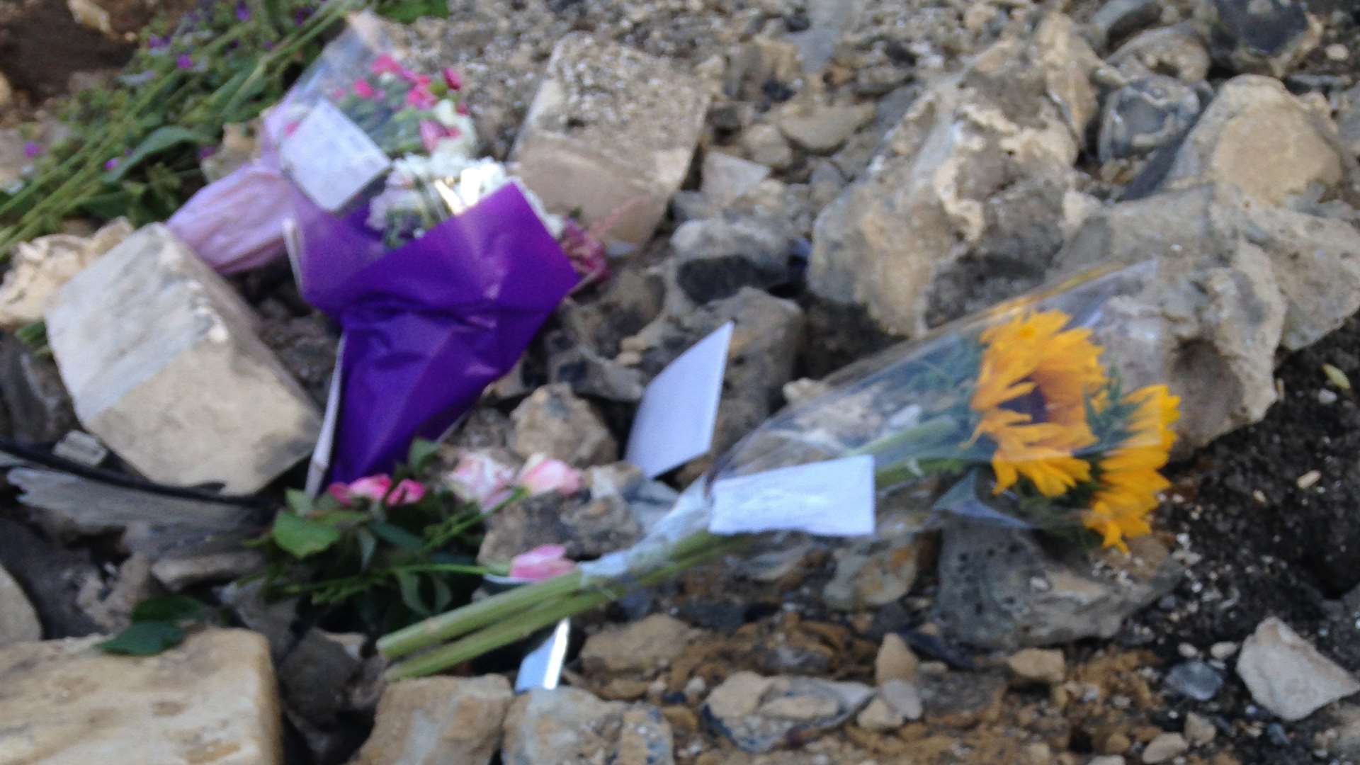 Floral tributes placed on the rubble where Peter O'Reilly died