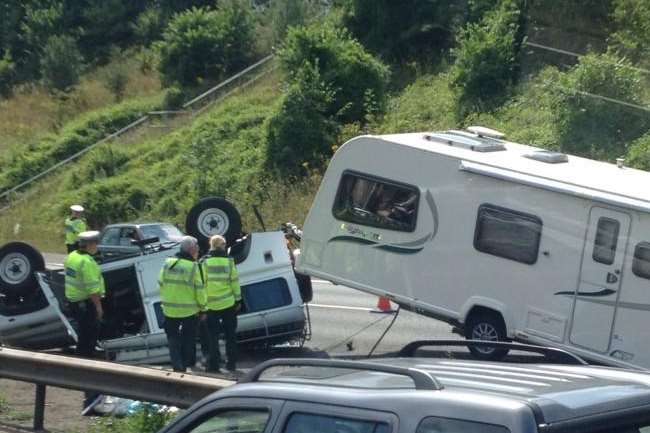 An overturned car pulling a caravan on the M25. Picture: @Kent_999s