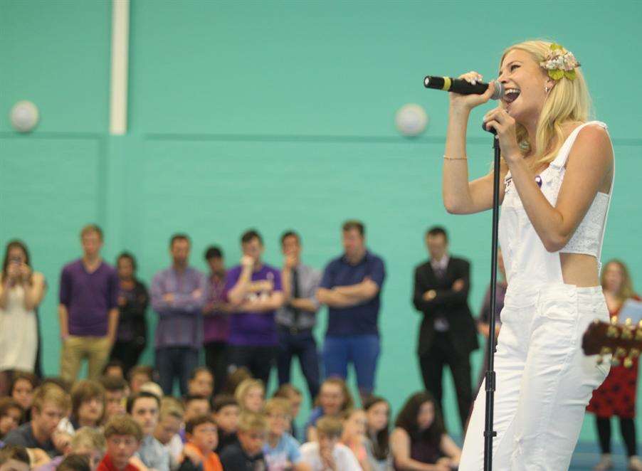 Pop star Pixie Lott performs to pupils at the High Weald Academy in Cranbrook