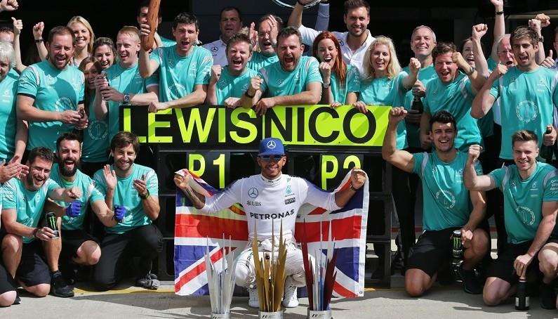 Lewis Hamilton celebrates with his trophies in 2016 (2906793)