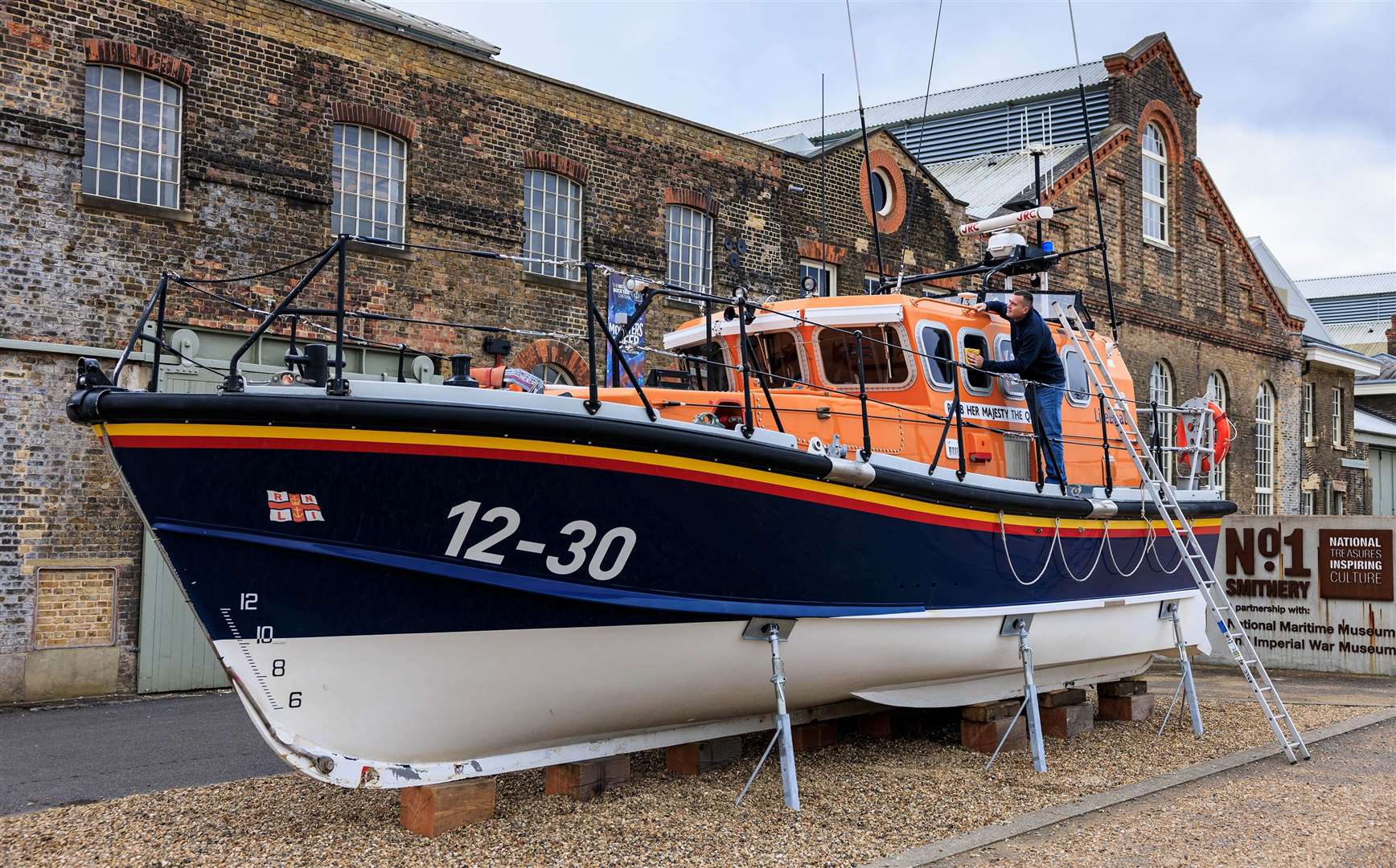 RNLI volunteer Stewart Challis settling the RNLB Her Majesty The Queen lifeboat into her new home at the dockyard. Picture: Historic Dockyard Chatham