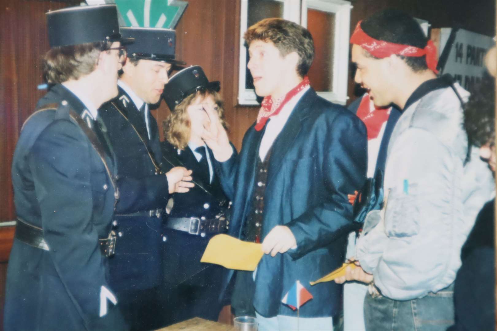 Neil Buchanan tries to evade 'customs' at a Motormouth 'wrap' party with Steve Johnson. Producer Vanessa Hill is dressed as a security guard. Made at the TVS studios in Maidstone