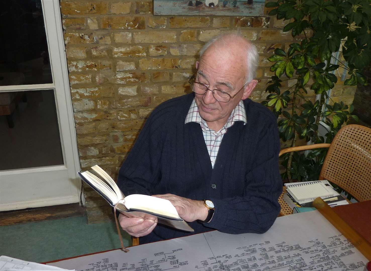 Roddy Tyndale-Biscoe with his replicated copy of the Tyndale Bible and a copy of the Tyndale family tree in 2010