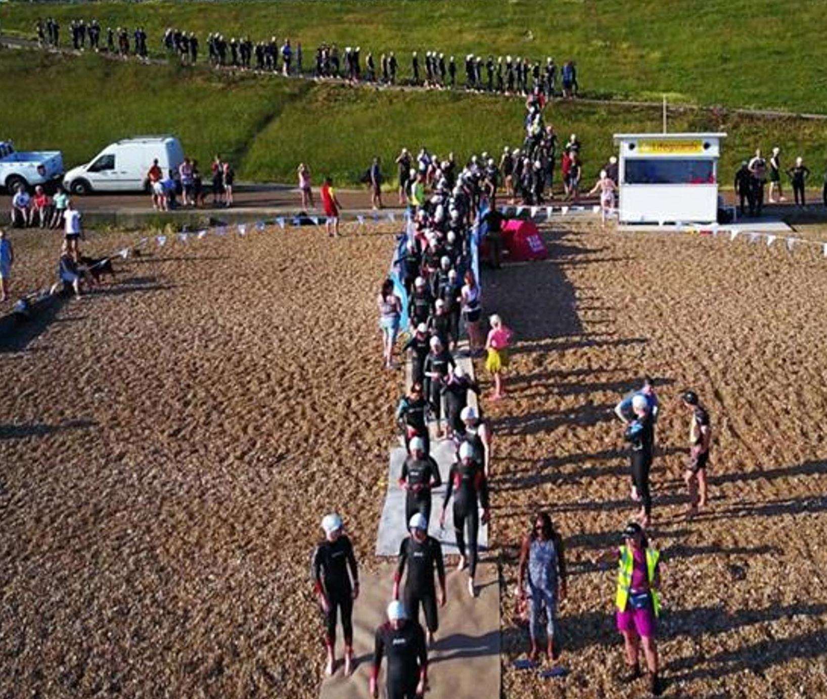 Competitors in last year's Oysterman Triathlon make their way down to the swim