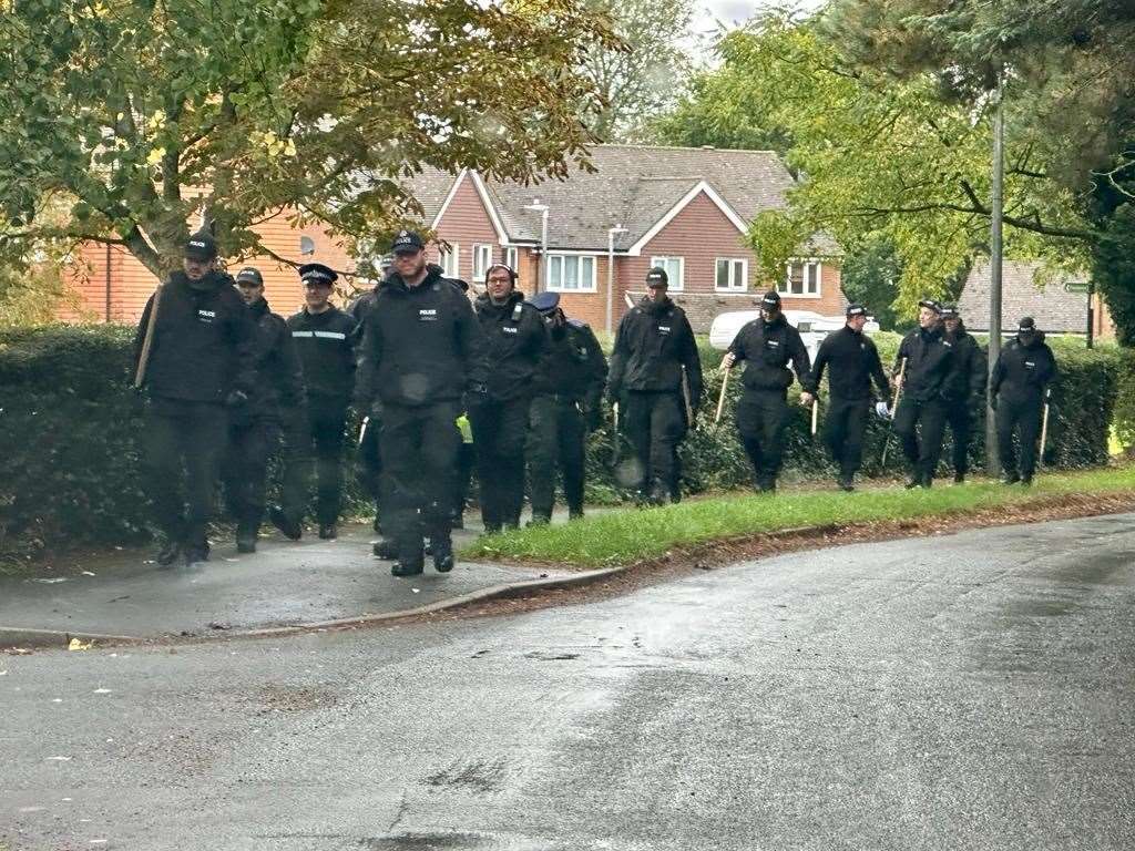 A large group of officers heading out of the village to woods this morning. Picture: Brian Flynn
