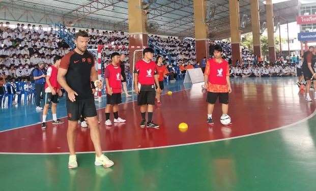 England Senior player Jamie Coyle coaches school children in Thailand during a break from playing