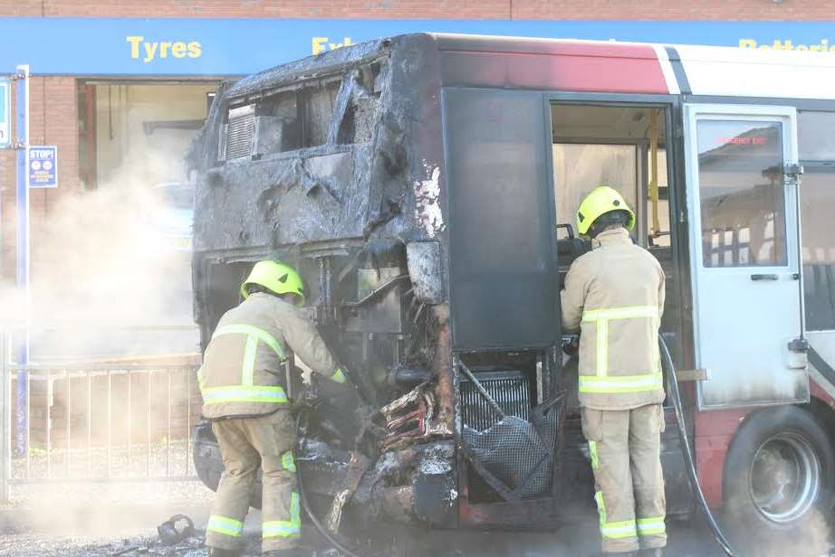 Firefighters cooling down the bus engine after the fire