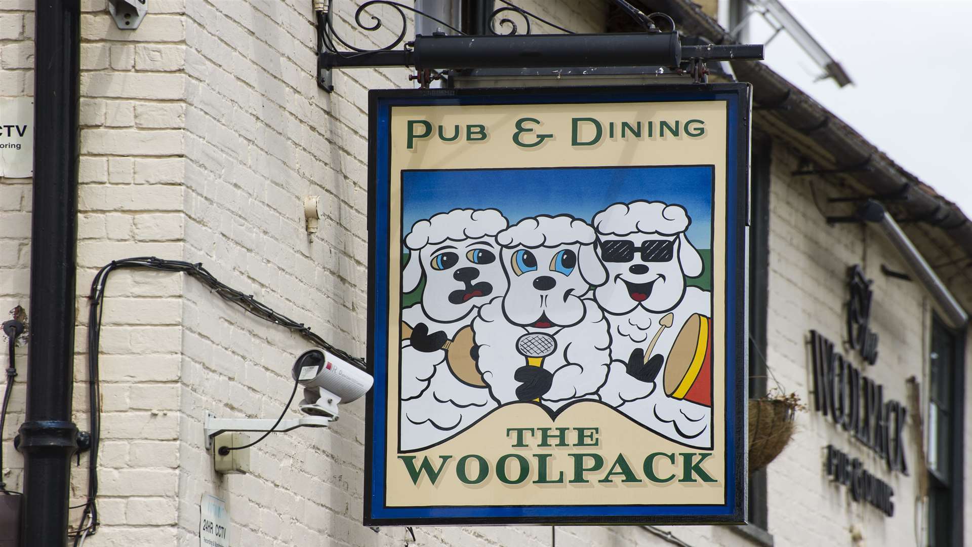 The Woolpack pub and its sign
