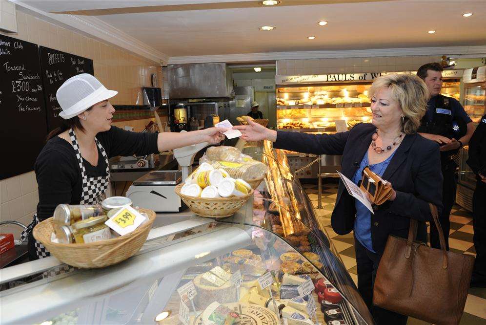 Ann Barnes buys some cheeses from Beverley Wyles at butchers Pauls of Whitstable