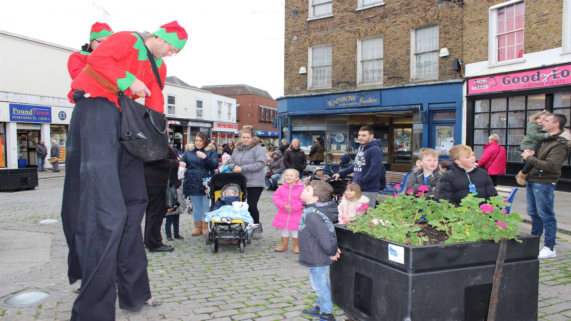 Tall story: Juggling stilt-walkers Alan Swan and Samantha Lambkin entertain the crowds at Sheerness Christmas Market
