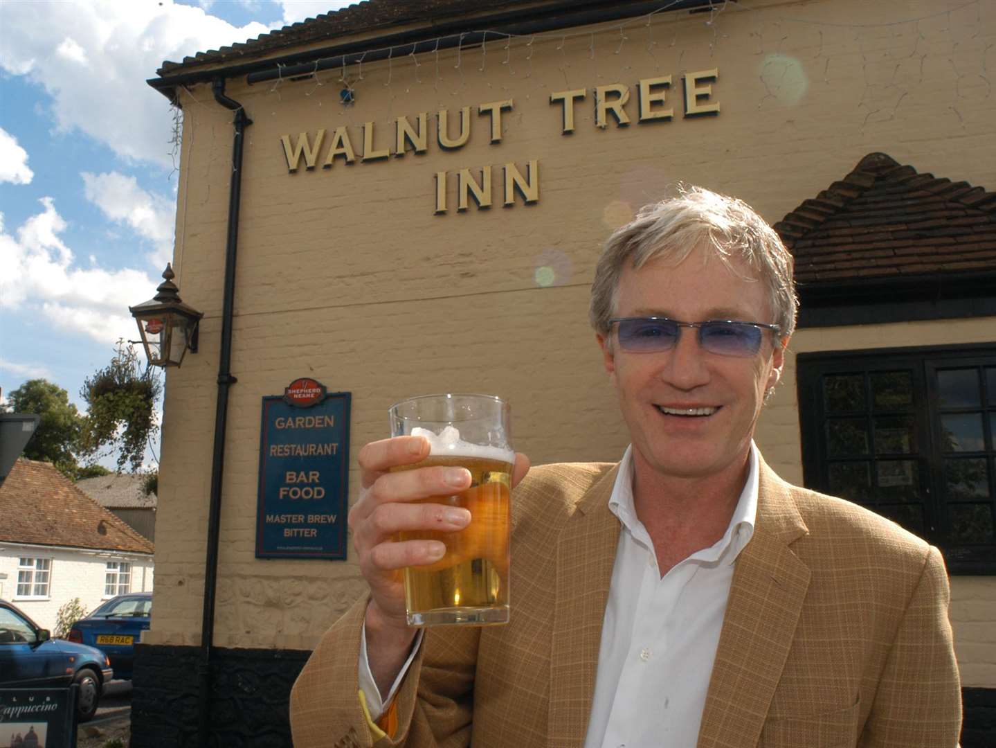 The late Paul O’Grady, who lived in Aldington, outside the Walnut Tree Inn in June 2004