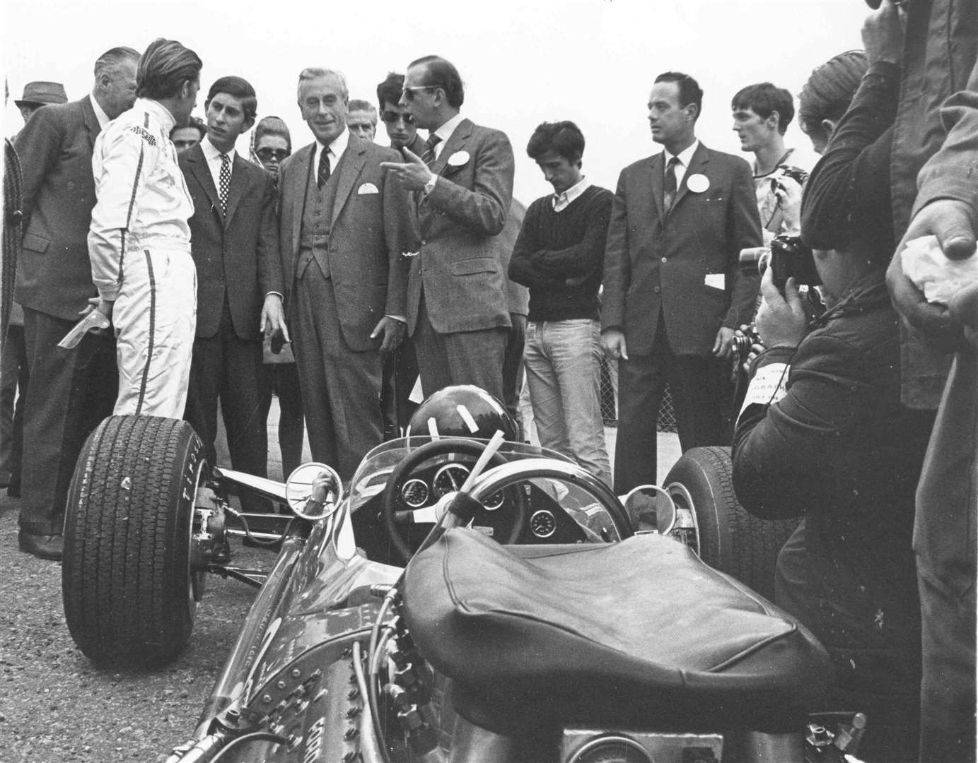 July 1968: Prince Charles drove to Brands Hatch in his blue MGC GT car, where he went to the paddock and met some of the top Grand Prix stars including John Surtees, Graham Hill - pictured here - and Denny Hulme