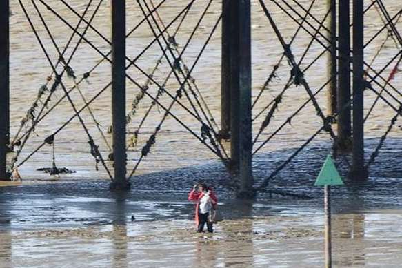 Woman stuck in the mud at Herne Bay pier. Image by Michael McLaughlin