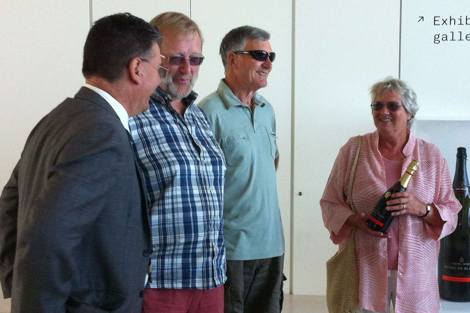 Sue Lewis is presented with her wine as the millionth visitor