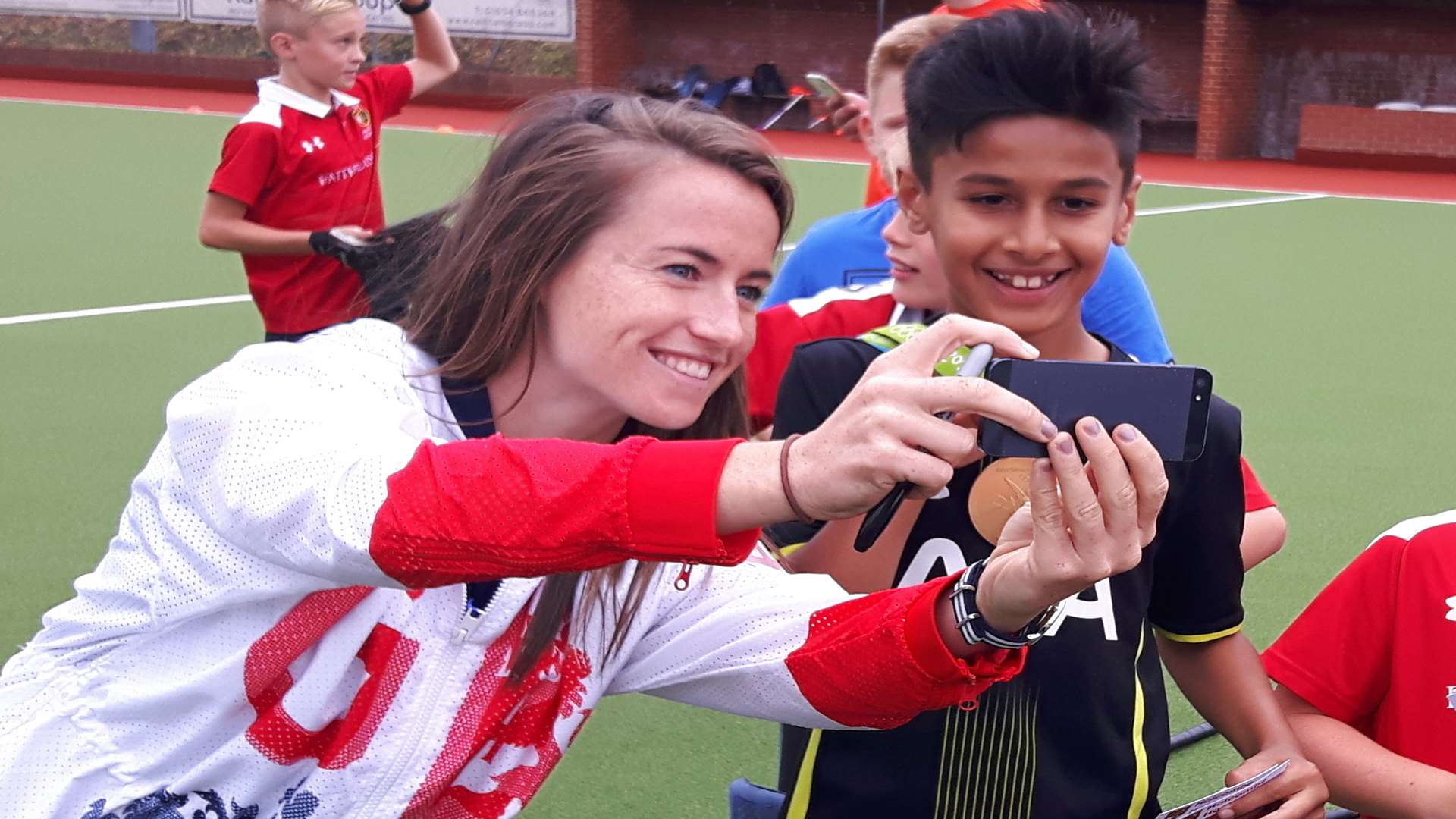 Maddie takes a selfie with a young fan at Holcombe Hockey Club
