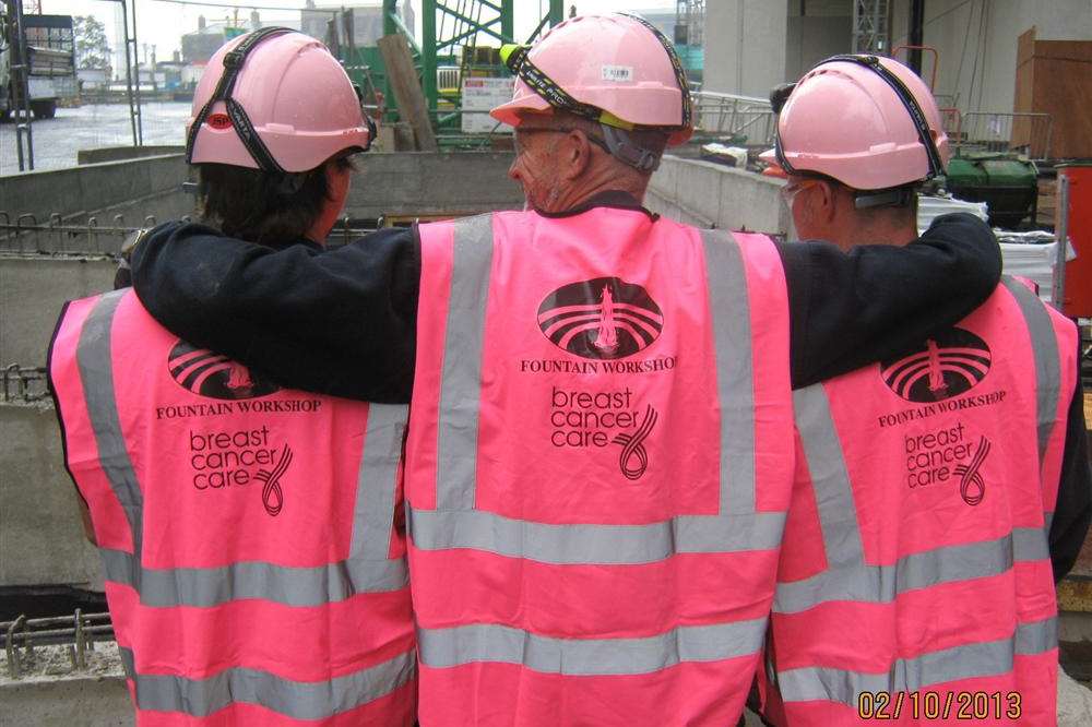 Employees at the Fountain Workshop wearing pink safety gear to support their boss David Bracey who has cancer