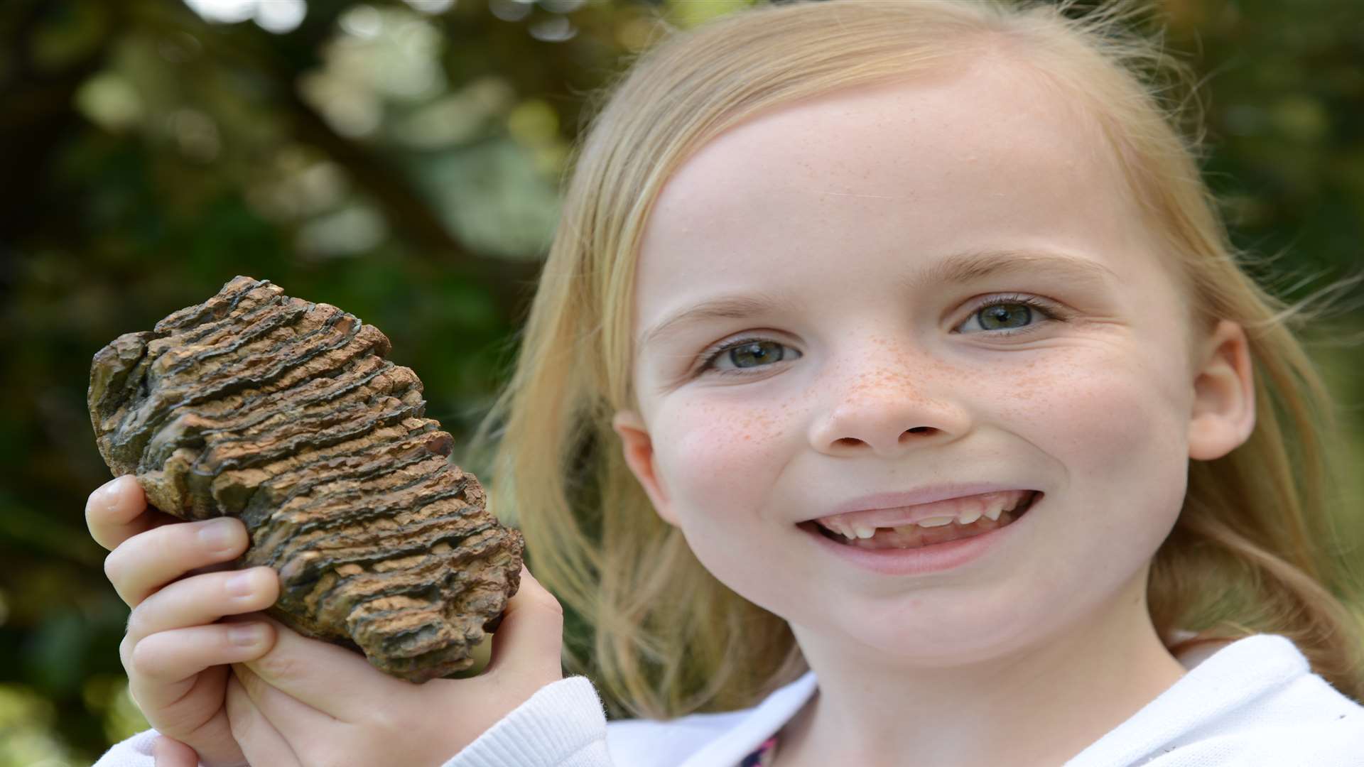 Seven-year-old Phoenix Renton says it feels special having her own mammoth tooth. Picture: Gary Browne